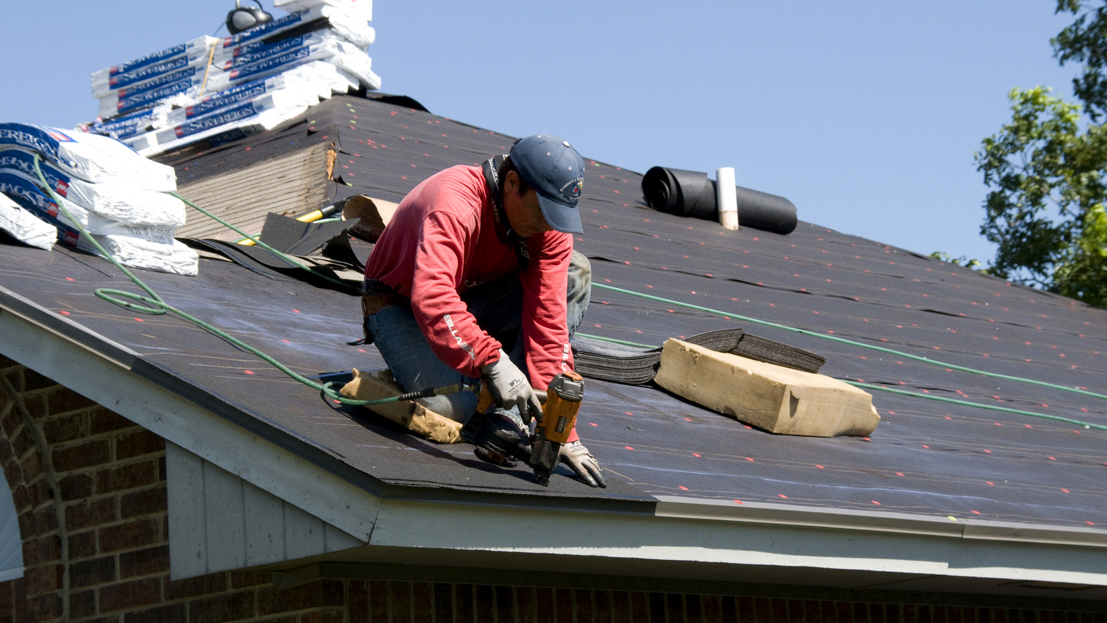 Illustration of a U.S. home roof with cost-analysis graphics